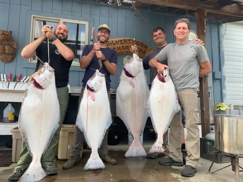 Four guys after their fishing trips with Silverthorne Charters